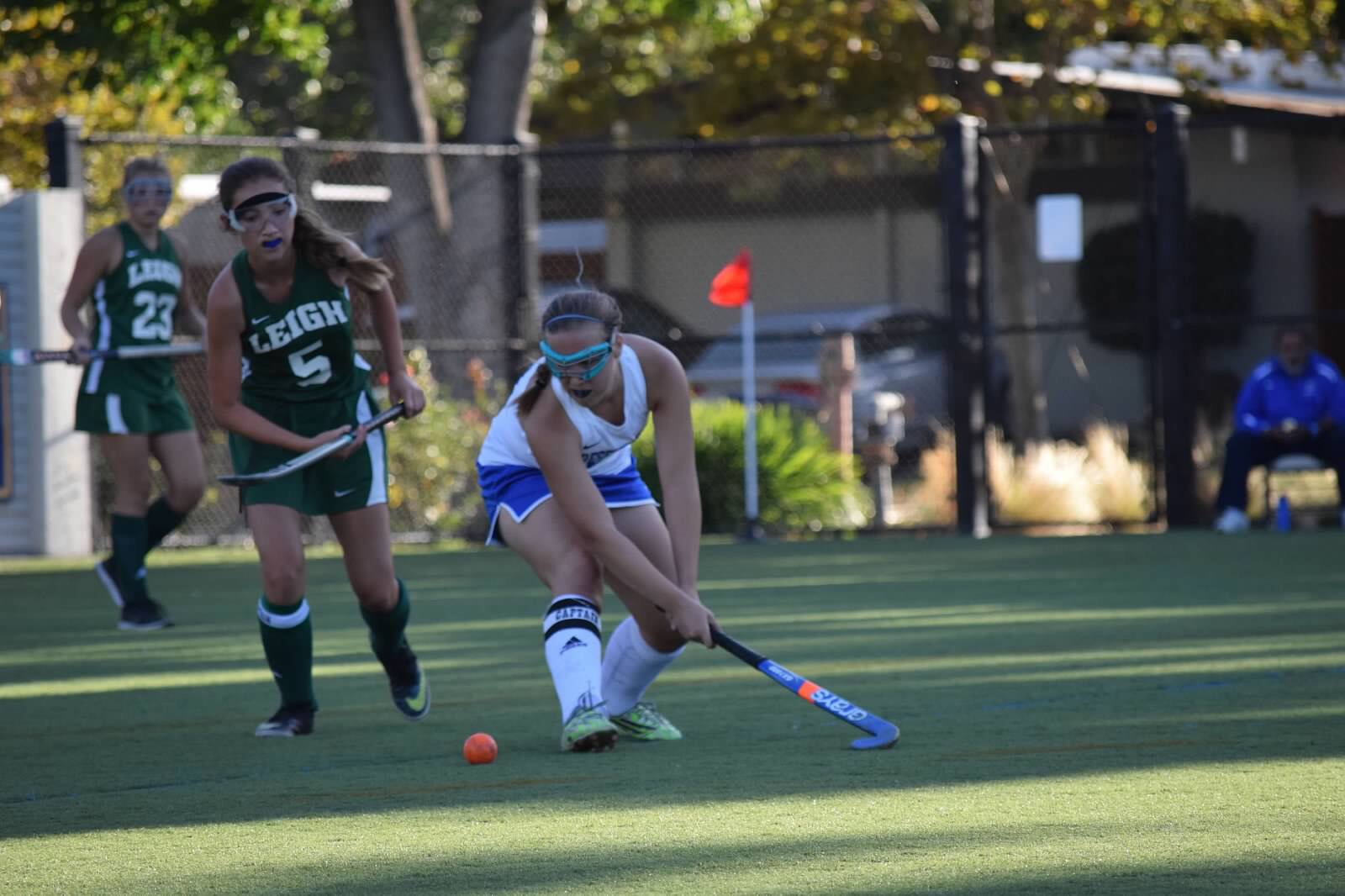 An action shot of Ashley playing field hockey.
